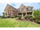 Well-maintained lawn and landscaping highlight this home's attractive brick front facade at 6585 Canyon Cv, Cumming, GA 30028