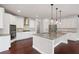 Gourmet kitchen boasts stainless steel appliances, granite countertops, and a center island at 6585 Canyon Cv, Cumming, GA 30028