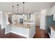 Modern kitchen featuring a center island, stainless steel appliances, and granite countertops at 6585 Canyon Cv, Cumming, GA 30028