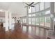 Open living room features hardwood floors, high ceilings, and an abundance of natural light at 6585 Canyon Cv, Cumming, GA 30028