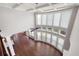Bright living room with hardwood floors, coffered ceilings, and large curved window wall at 6585 Canyon Cv, Cumming, GA 30028