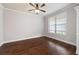 Comfortable living room featuring hardwood floors, a ceiling fan, and natural light at 6585 Canyon Cv, Cumming, GA 30028