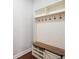 Mudroom with built-in storage including cabinets, shelves, hooks, and bench at 6585 Canyon Cv, Cumming, GA 30028