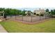 Fenced playground with swings and slides, surrounded by a grassy area, perfect for outdoor fun at 6585 Canyon Cv, Cumming, GA 30028