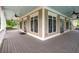 Expansive covered porch with ceiling fans, offering a relaxing outdoor space with ample natural light at 6585 Canyon Cv, Cumming, GA 30028