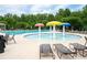 Fun splash pad with vibrant mushroom-shaped water features, surrounded by lounge chairs and lush greenery at 6585 Canyon Cv, Cumming, GA 30028