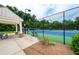 Community tennis court behind a gazebo, featuring a well-maintained surface and surrounding greenery at 6585 Canyon Cv, Cumming, GA 30028