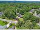 An aerial view of a charming home surrounded by lush trees, and a nearby paved road at 905 John Ward Rd, Marietta, GA 30064