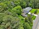 Aerial view of home with large lawn, backing to woods, and near a two-lane road at 905 John Ward Rd, Marietta, GA 30064