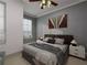 Well-lit bedroom featuring two windows, ceiling fan, decorative artwork, and a comfortable bed with stylish accents at 1161 Dahlonega Hwy # 12, Cumming, GA 30040