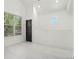 Bright bedroom featuring large windows and a modern black door at 1473 Lansing Se St, Atlanta, GA 30315