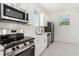 Modern kitchen features stainless steel appliances, white cabinets, and ample counter space at 1473 Lansing Se St, Atlanta, GA 30315