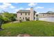 Large backyard with a white vinyl fence, green grass, and patio area at 211 Millstone Dr, Hampton, GA 30228