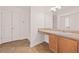 Bright bathroom with updated vanity, flooring, and convenient double door linen closet at 211 Millstone Dr, Hampton, GA 30228