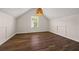 Bedroom with vaulted ceilings, modern light fixture, and wood-look flooring at 211 Millstone Dr, Hampton, GA 30228