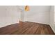 Bedroom featuring wood-look flooring, vaulted ceiling, closet doors, and window at 211 Millstone Dr, Hampton, GA 30228