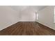 Bonus room featuring vaulted ceiling, natural light from window and plank flooring at 211 Millstone Dr, Hampton, GA 30228