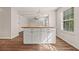 Kitchen island featuring white cabinets, dark hardware and butcher block countertop at 211 Millstone Dr, Hampton, GA 30228