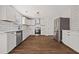 Modern kitchen featuring white cabinets, stainless steel appliances, and subway tile backsplash at 211 Millstone Dr, Hampton, GA 30228