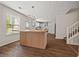 Modern kitchen with wood-paneled island, stainless appliances, and light-filled windows at 211 Millstone Dr, Hampton, GA 30228
