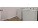 Bright laundry room with tile floor and modern washer and dryer units at 211 Millstone Dr, Hampton, GA 30228