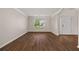 Well-lit living room features hardwood floors, a large window, and stylish white trim at 211 Millstone Dr, Hampton, GA 30228