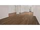 Spacious living area with hardwood floors, wainscoting, and contemporary light fixture at 211 Millstone Dr, Hampton, GA 30228