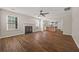 Open living room and kitchen area with dark stained floors and a fireplace at 211 Millstone Dr, Hampton, GA 30228