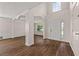 Bright living room showcasing hardwood floors, decorative columns, and vaulted ceiling at 211 Millstone Dr, Hampton, GA 30228