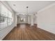 Bright living room features hardwood floors, wainscoting, and contemporary light fixture at 211 Millstone Dr, Hampton, GA 30228