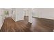 Open-concept living space featuring hardwood floors, white trim, and modern lighting at 211 Millstone Dr, Hampton, GA 30228