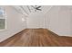 Spacious main bedroom featuring tray ceiling, ceiling fan, and hardwood floors at 211 Millstone Dr, Hampton, GA 30228
