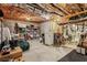 Unfinished basement area with exposed beams and various storage items, including shelves and appliances at 2115 Howell Mill Nw Rd, Atlanta, GA 30318
