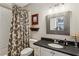 Neutral bathroom with a shower/tub combination, patterned shower curtain, and sleek vanity at 2115 Howell Mill Nw Rd, Atlanta, GA 30318