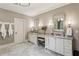 Elegant bathroom features double sinks with granite countertops, vanity and marble tile floors at 2115 Howell Mill Nw Rd, Atlanta, GA 30318