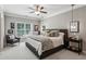 Stylish primary bedroom featuring a large bed, seating area, and modern lighting fixtures for a serene retreat at 2115 Howell Mill Nw Rd, Atlanta, GA 30318