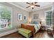 Comfortable bedroom featuring a wood-framed bed, bright windows, and tasteful decor at 2115 Howell Mill Nw Rd, Atlanta, GA 30318