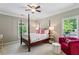 Inviting bedroom with a four-poster bed, plush seating, and natural light streaming through the windows at 2115 Howell Mill Nw Rd, Atlanta, GA 30318