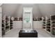 Spacious walk-in closet with custom shelving and drawers for optimal organization and a center island at 2115 Howell Mill Nw Rd, Atlanta, GA 30318