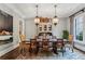 Elegant dining room with dark wood floors, decorative chandelier, and large painting on the wall at 2115 Howell Mill Nw Rd, Atlanta, GA 30318