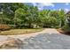 Wide driveway with manicured lawn, landscaping, and mature trees at 2115 Howell Mill Nw Rd, Atlanta, GA 30318
