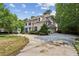 Two-story brick home with private drive and mature landscaping, enhanced by a well-manicured lawn at 2115 Howell Mill Nw Rd, Atlanta, GA 30318