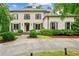 Traditional brick home with manicured front yard, mature trees, and long driveway at 2115 Howell Mill Nw Rd, Atlanta, GA 30318