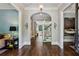 Elegant hallway with hardwood floors, arched entryways, and staircase to the second floor at 2115 Howell Mill Nw Rd, Atlanta, GA 30318