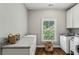 Well-lit laundry room features granite countertops, a sink, ample cabinet space, and modern appliances at 2115 Howell Mill Nw Rd, Atlanta, GA 30318