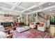 Spacious living room showcasing hardwood floors, coffered ceiling, and open layout with stairs and kitchen at 2115 Howell Mill Nw Rd, Atlanta, GA 30318