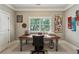 Cozy home office featuring a wooden desk, office chair, and bright natural light from the window at 2115 Howell Mill Nw Rd, Atlanta, GA 30318