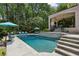 Beautiful pool area with a waterfall feature, surrounded by lush greenery and comfortable lounge chairs at 2115 Howell Mill Nw Rd, Atlanta, GA 30318