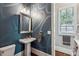 Stylish powder room with pedestal sink, modern mirror, and decorative wallpaper at 2115 Howell Mill Nw Rd, Atlanta, GA 30318