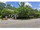 Elegant home with mature trees and landscaping, complemented by a fenced yard and street view at 2115 Howell Mill Nw Rd, Atlanta, GA 30318